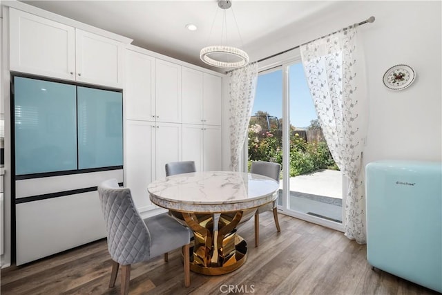 dining space with wood-type flooring