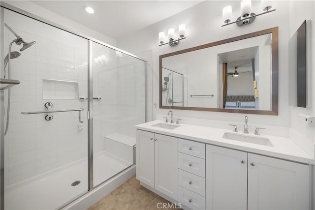 bathroom with an enclosed shower, vanity, and tile patterned flooring