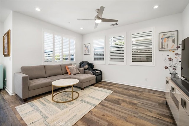 living room with ceiling fan and dark hardwood / wood-style flooring