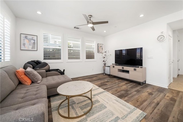 living room with ceiling fan, dark wood-type flooring, and plenty of natural light