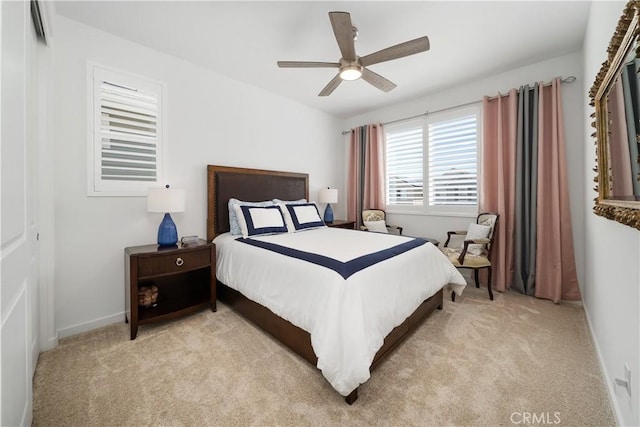 bedroom featuring ceiling fan, light colored carpet, and a closet