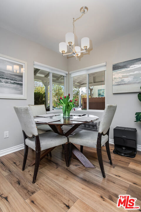 dining area featuring an inviting chandelier and wood-type flooring