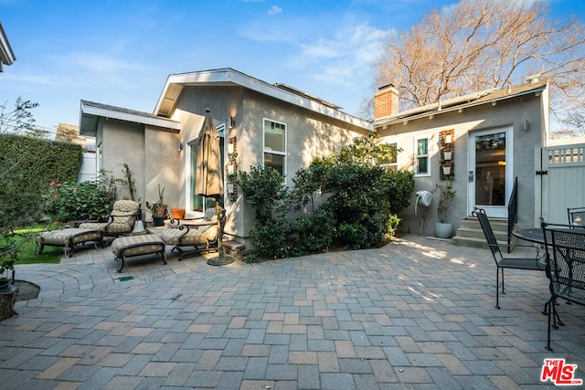 back of house with a patio area