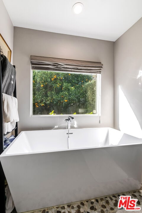 bathroom featuring a tub to relax in