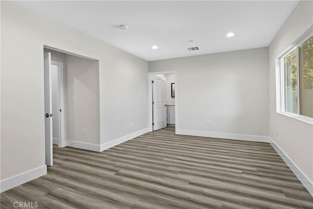 empty room featuring dark hardwood / wood-style flooring