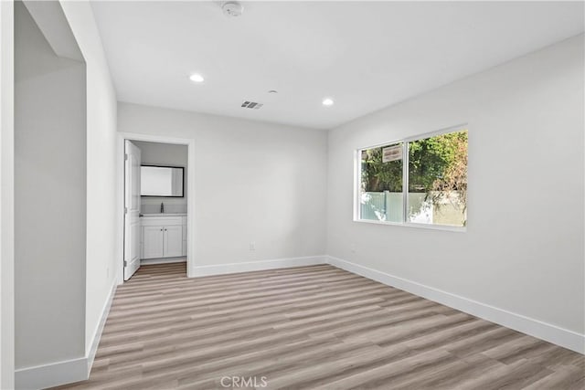 spare room with light hardwood / wood-style floors