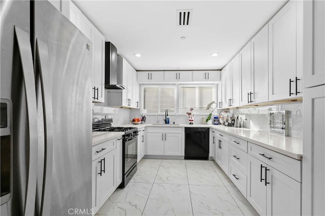 kitchen with tasteful backsplash, wall chimney range hood, black appliances, white cabinets, and sink