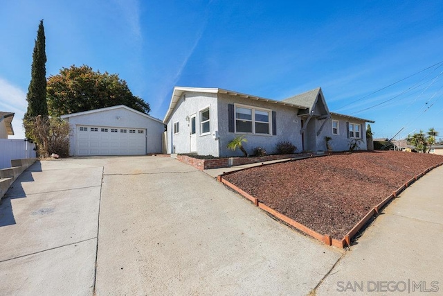 single story home with a garage and an outdoor structure