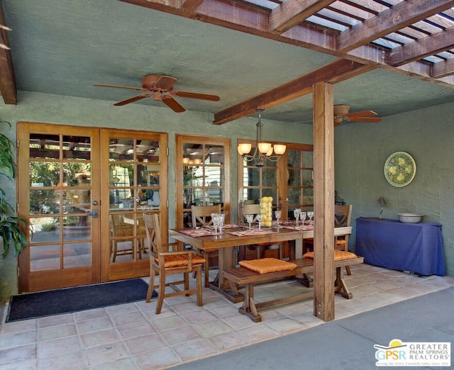 interior space with ceiling fan with notable chandelier, beam ceiling, and french doors