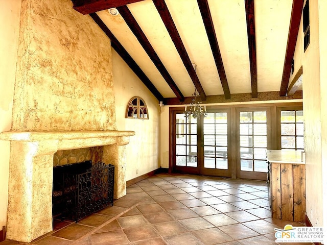 unfurnished living room with french doors, a stone fireplace, high vaulted ceiling, a chandelier, and beamed ceiling