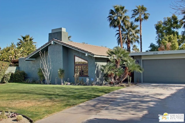 single story home with a garage and a front lawn