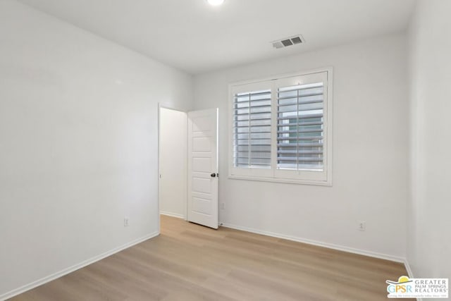 spare room with light hardwood / wood-style floors