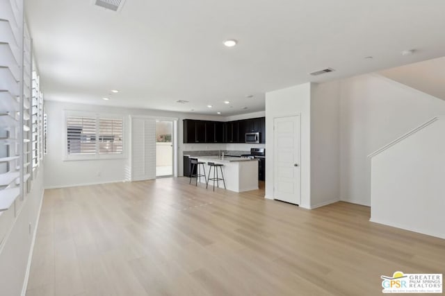 unfurnished living room with light hardwood / wood-style floors