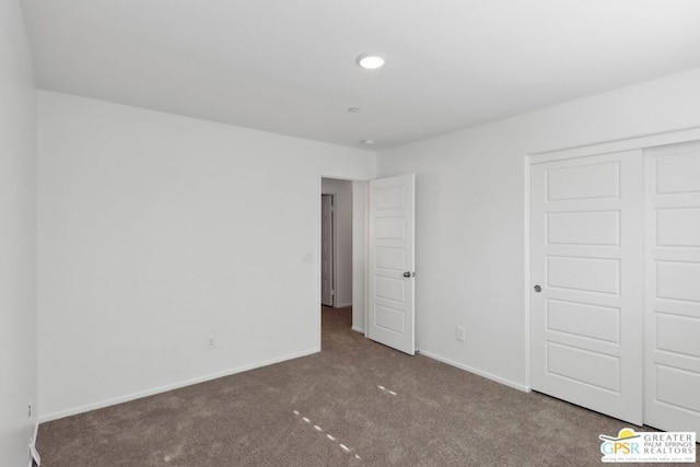 unfurnished bedroom with a closet and carpet floors