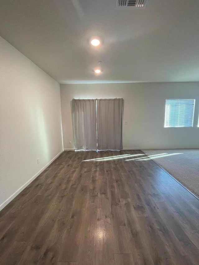 empty room featuring dark hardwood / wood-style flooring