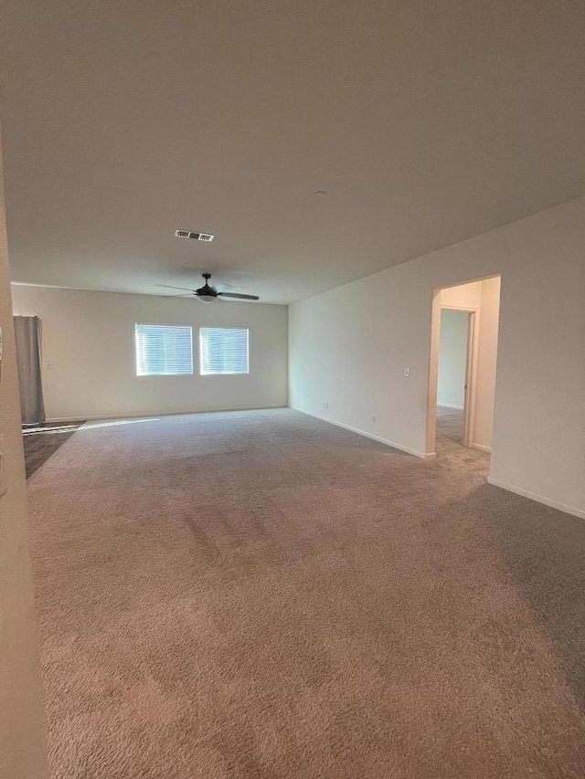 empty room featuring light carpet and ceiling fan