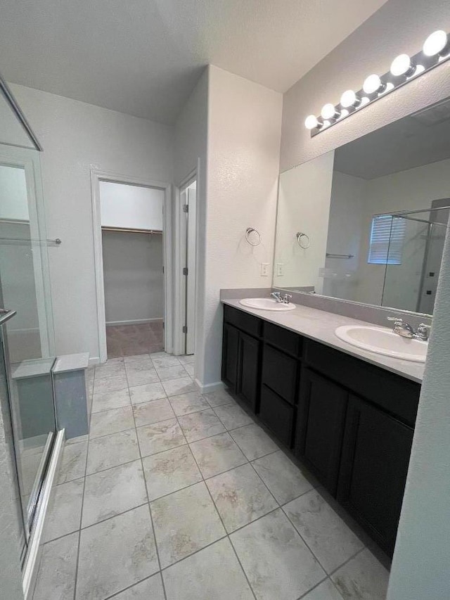 bathroom featuring walk in shower, vanity, and a textured ceiling