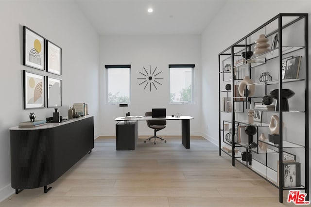 home office with light hardwood / wood-style floors