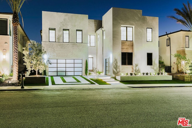 view of front of home with a garage and a front yard