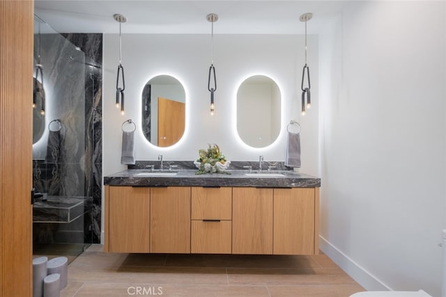 bathroom featuring a shower, vanity, and tile patterned flooring