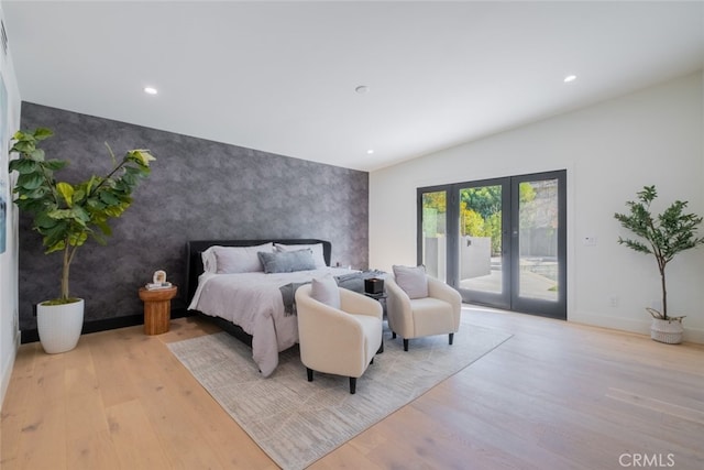 bedroom with access to exterior, french doors, and light hardwood / wood-style flooring