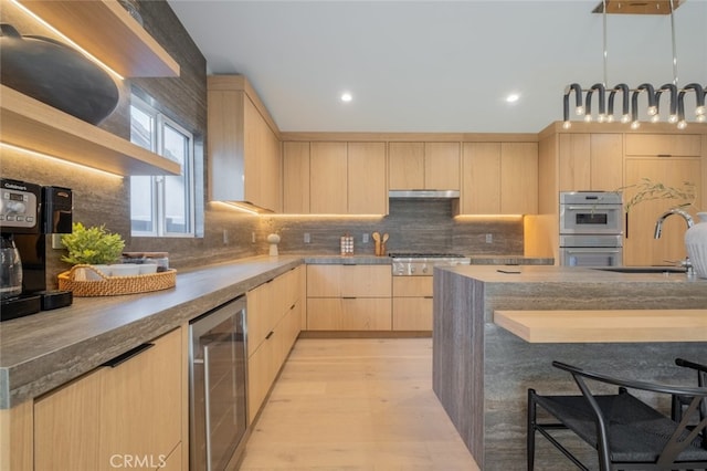 kitchen featuring light hardwood / wood-style floors, sink, appliances with stainless steel finishes, light brown cabinetry, and beverage cooler