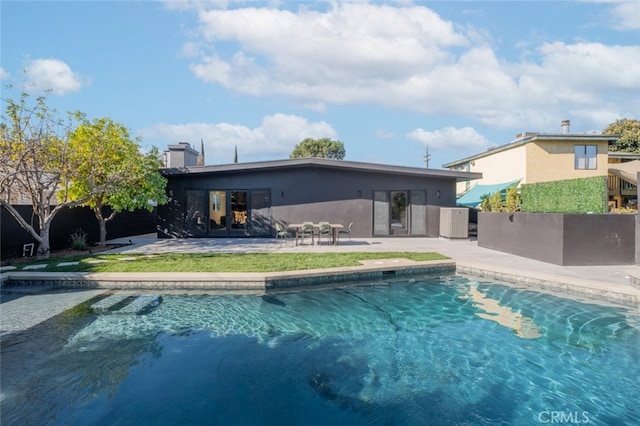 view of pool featuring central air condition unit and a patio