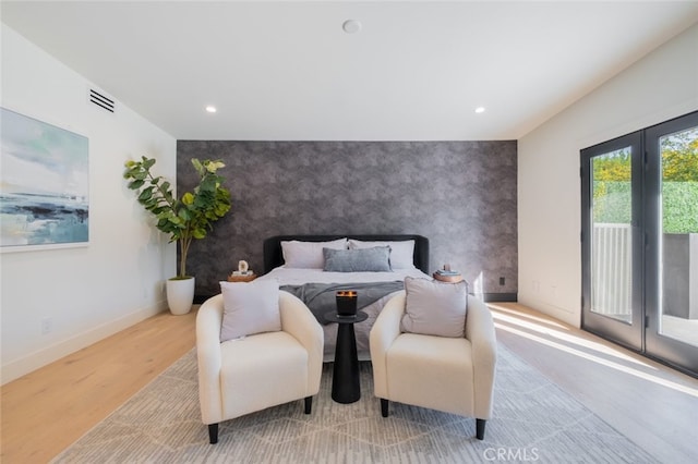 bedroom featuring light hardwood / wood-style floors and access to outside