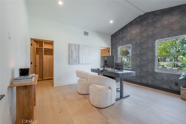 office area featuring light hardwood / wood-style floors and lofted ceiling with beams