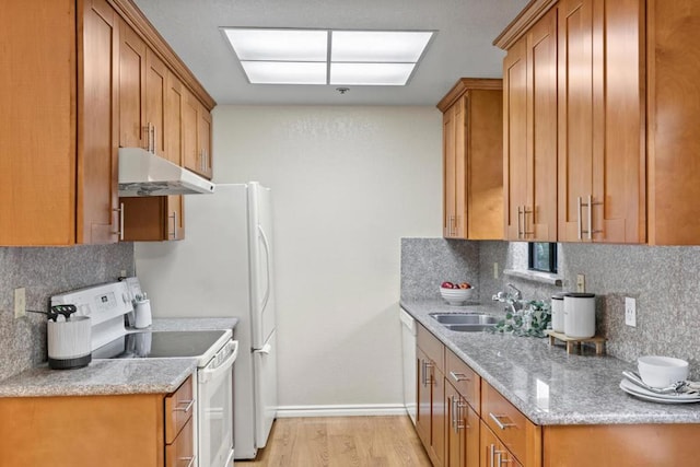 kitchen featuring white electric stove, sink, backsplash, light stone counters, and light hardwood / wood-style flooring