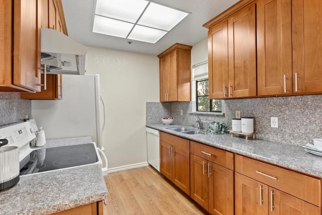 kitchen with sink, range with electric stovetop, white dishwasher, light hardwood / wood-style floors, and decorative backsplash