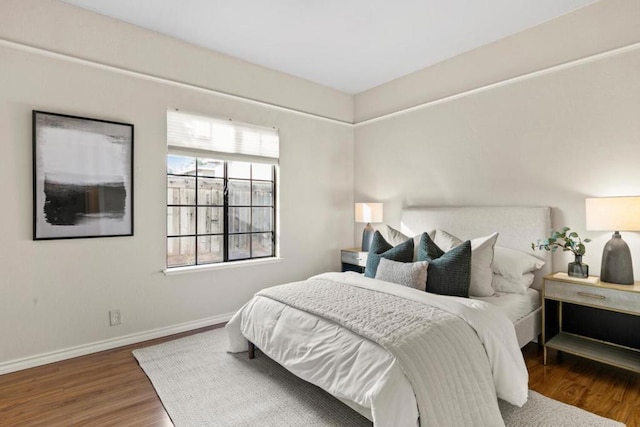 bedroom with dark hardwood / wood-style flooring