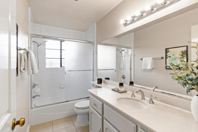 full bathroom featuring tile patterned flooring, bath / shower combo with glass door, vanity, and toilet