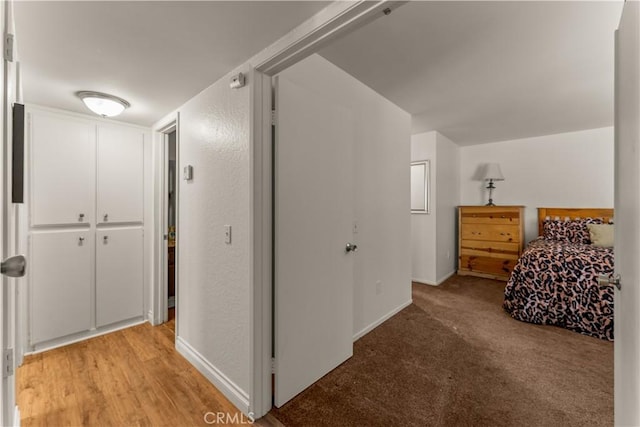 unfurnished bedroom with light colored carpet and a closet