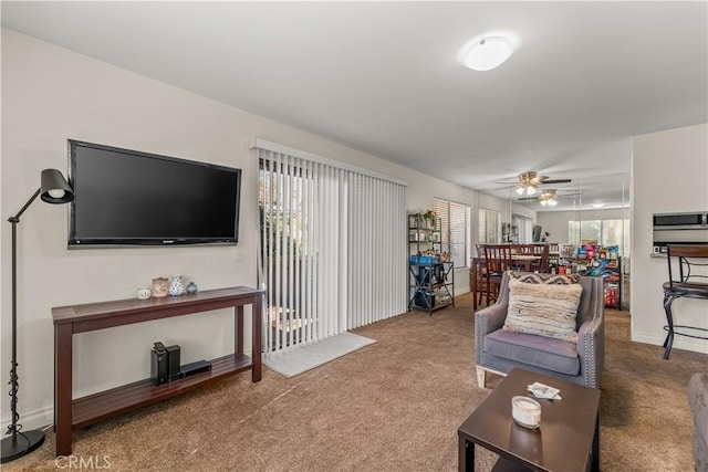 carpeted living room with ceiling fan