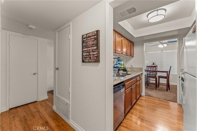 kitchen featuring dishwasher, sink, refrigerator, ceiling fan, and light hardwood / wood-style flooring