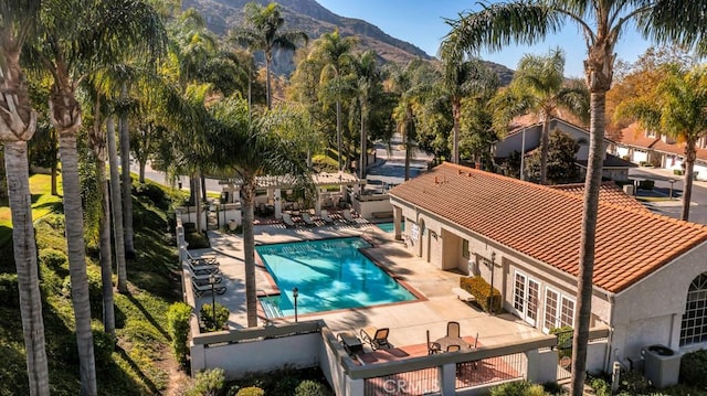 view of pool with central AC unit, a patio area, a mountain view, and french doors