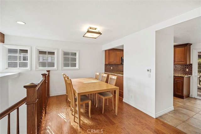 dining space with light wood-type flooring