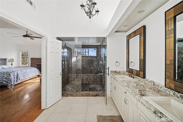 bathroom featuring a shower with shower door, tile patterned floors, vanity, and ceiling fan