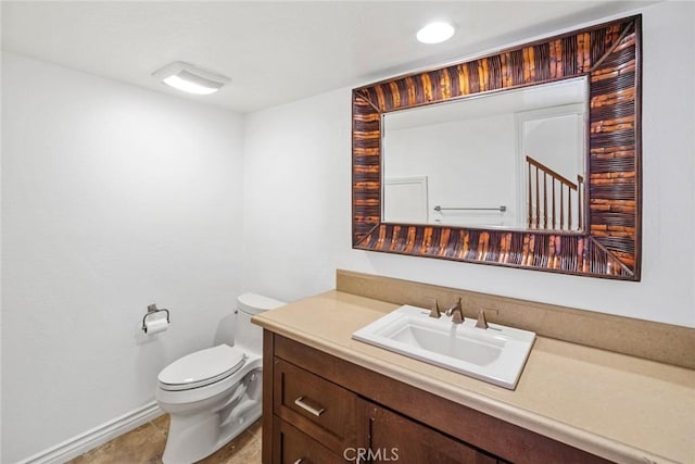 bathroom featuring toilet, vanity, and tile patterned flooring