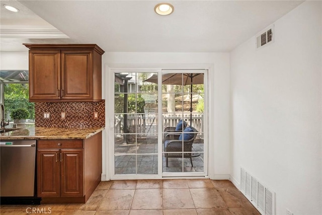 interior space with sink, stone countertops, stainless steel dishwasher, and a wealth of natural light