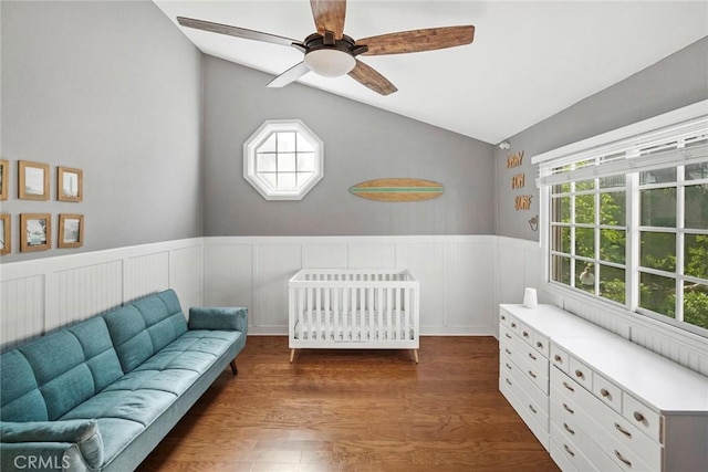 bedroom with ceiling fan, multiple windows, a nursery area, and vaulted ceiling