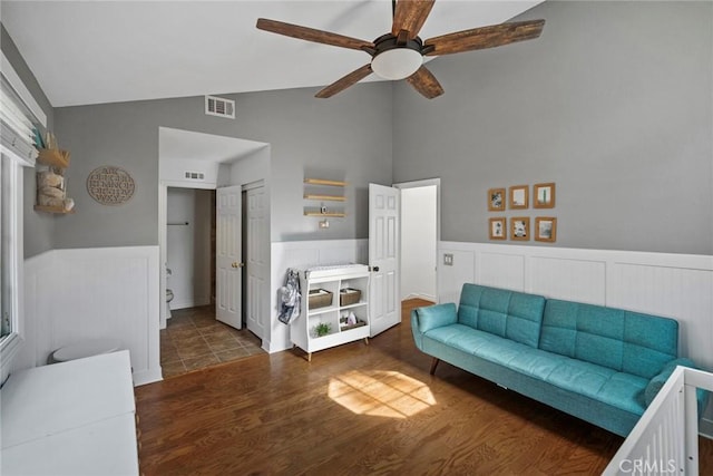 living room with lofted ceiling, ceiling fan, and dark hardwood / wood-style flooring