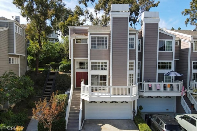 view of property featuring a garage and a balcony