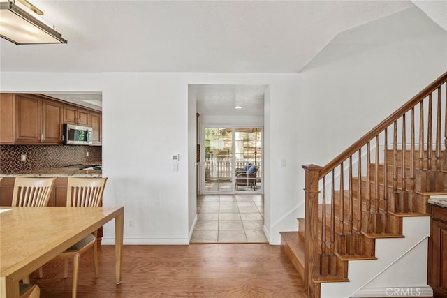 interior space with tasteful backsplash and light wood-type flooring