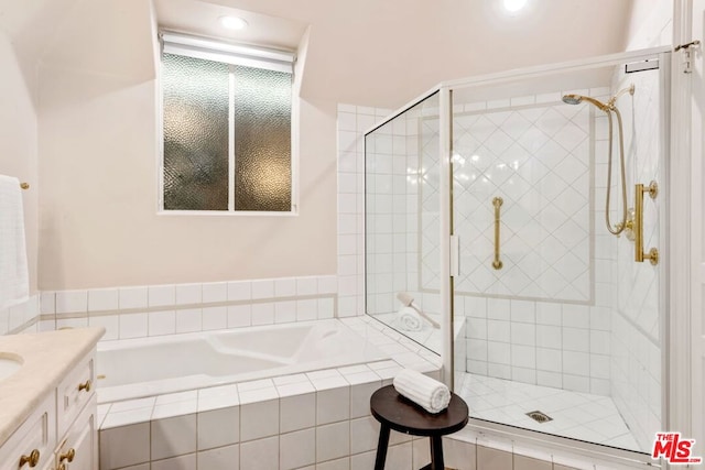 bathroom featuring vanity and plus walk in shower