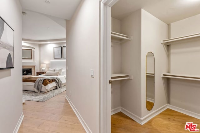 hallway with light hardwood / wood-style floors