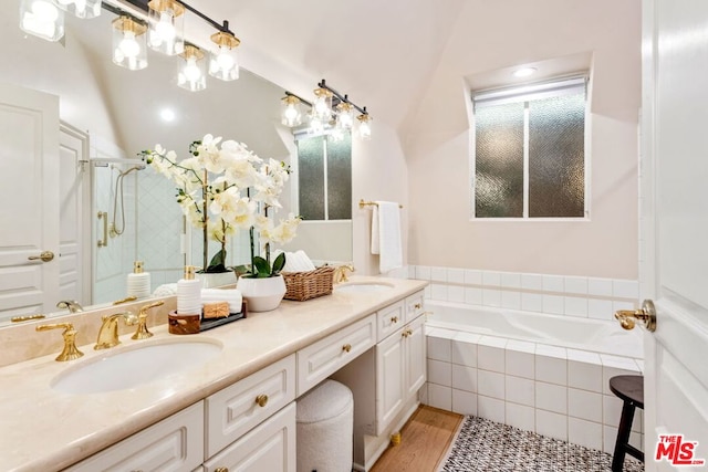 bathroom featuring wood-type flooring, vanity, and separate shower and tub