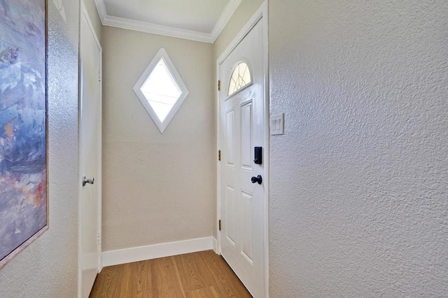 entryway with crown molding and hardwood / wood-style flooring