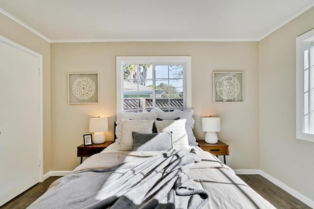 bedroom with dark wood-type flooring and crown molding